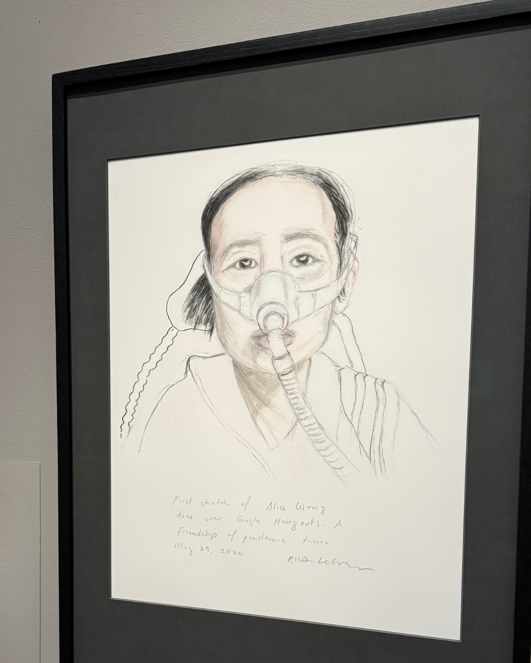 Riva Lehrer’s “Zoom Portraits: Alice Wong (Study),” National Portrait Gallery. On the portrait, Lehrer wrote, “First sketch of Alice Wong done over Google Hangouts. A friendship of pandemic times. May 29, 2020.” Drawn with graphite and colored pencil, she wears a neutral expression while connected to a ventilator with her hair pulled back.